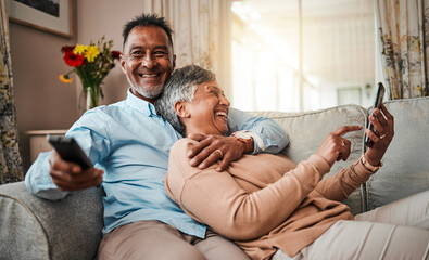 Senior couple, phone and watching tv on home sofa with a remote control, happiness and love. Mature...