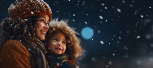 mother with her daughter on the snowy Christmas night looking forward to the arrival of Santa Claus - copy space
