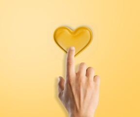 Hands holding a small yellow heart