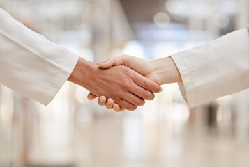 Doctors, partnership and handshake for collaboration, agreement and teamwork. Shaking hands,...
