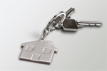 House key and shaped keyring on desk