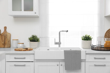 Different potted artificial plants on countertop in kitchen. Home decor