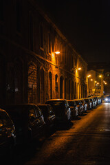 Cars parked on the side of a road at night