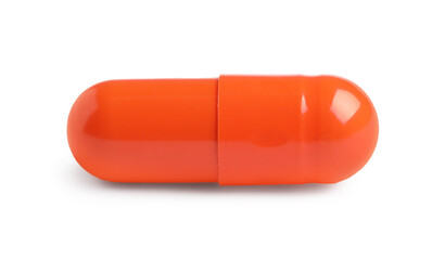 One orange pill on white background. Medicinal treatment