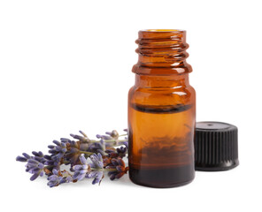Bottle of essential oil and lavender flowers on white background