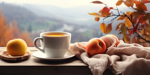 Tuinposter Cup of hot coffee ,apples, knitted scarf, on the window age with autumn scene outside, © tashechka