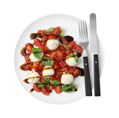 Tasty salad Caprese with tomatoes, mozzarella balls, basil and cutlery on white background, top view