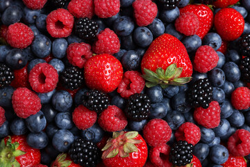 Different fresh ripe berries as background, top view