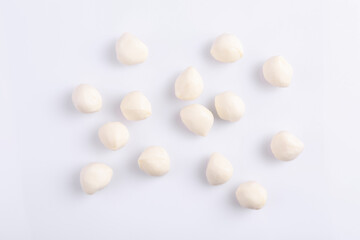 Fototapeta na wymiar Tasty mozzarella balls on white background, flat lay