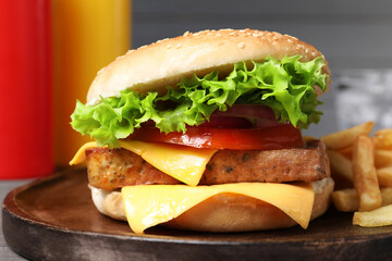 Delicious tofu burger served with french fries on board, closeup