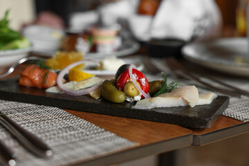 Tasty appetizers served on table in cafe, closeup
