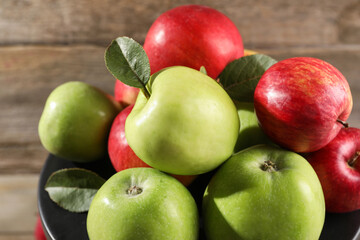 Fresh ripe red and green apples on wooden table, closeup
