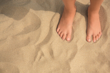 Little girl standing on sandy beach, closeup. Space for text - Powered by Adobe