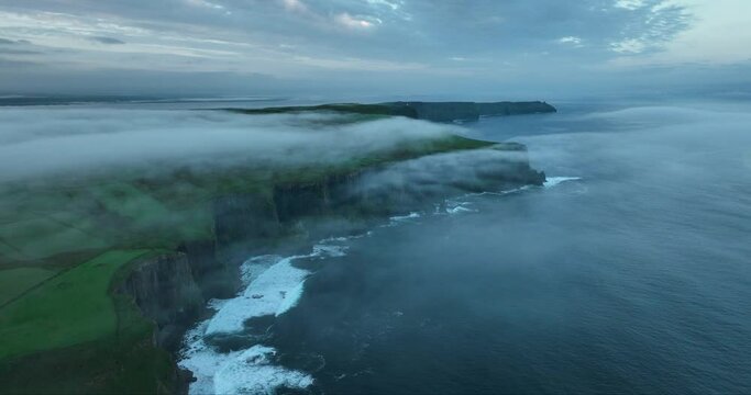 Flying in the clouds above the Cliffs of Moher 4k