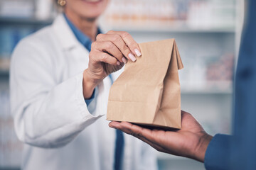Woman, pharmacist and hands with medication for patient, healthcare or paper bag at the pharmacy....