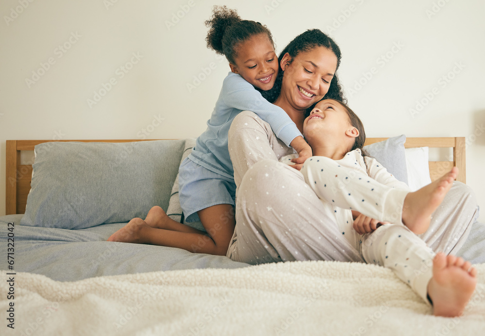 Wall mural Mother, bed and children hug or happy with parent together in the morning laughing in a bedroom in a home. Funny, bonding and mom enjoy quality time with kids or girls with happiness and love