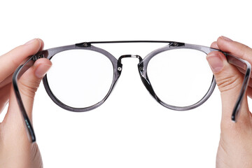 Woman holding stylish glasses with grey frame on white background, closeup