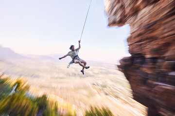 Sports, rock climbing and jump with man on mountain for fitness, adventure and challenge. Rope,...
