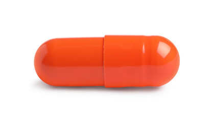 One orange pill on white background. Medicinal treatment