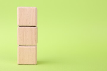International Organization for Standardization. Wooden cubes with abbreviation ISO on light green...