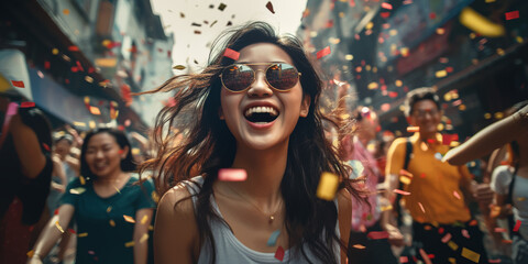 Celebrating happiness, young asia woman afro hair dancing with big smile throwing colorful confetti in festival Party
