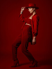 Aesthetic, fashion and a model woman on a red studio background for elegant or trendy style....