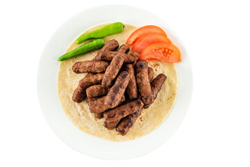 Turkish style meatballs. in a white plate with lavash.