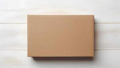 Top view of elongated rectangular beige parcel cardboard box with blank space on light white wooden surface. Messenger and delivery service concept.