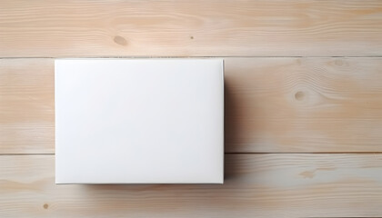 Top down view of white elongated parcel cardboard box with blank space on light beige wooden surface. Messenger and delivery service concept.	