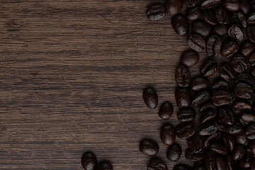 Roasted coffee bean on wooden table..