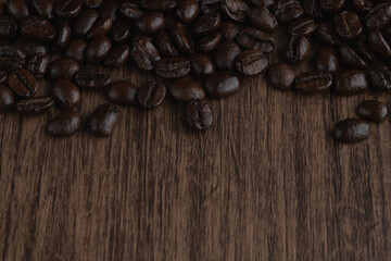 Roasted coffee bean on wooden table..