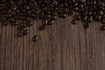 Roasted coffee bean on wooden table..
