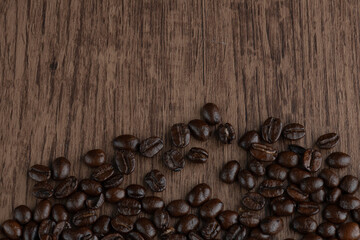 Roasted coffee bean on wooden table..