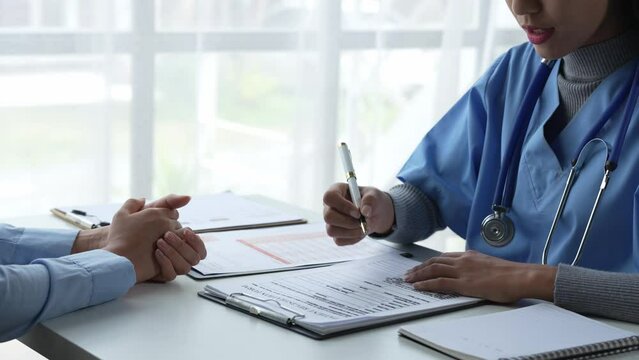 Asian female doctor or medical specialist examining a patient Ask for symptoms, give advice, recommend medication, plan treatment guidelines and preventive care. Concept of health checkup Prevention.