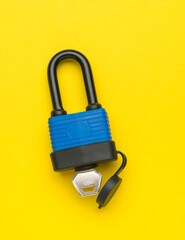 Closed all-weather lock on a yellow background.