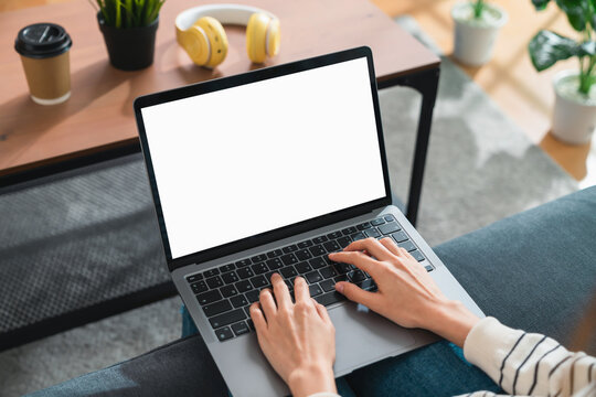 Woman hand type on the keyboard on laptop with mockup of blank screen for the application.