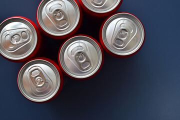 close up top of aluminium red cans soft drink put on blue texture background