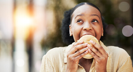Mockup, fast food and black woman eating a burger in an outdoor restaurant as a lunch meal craving deal. Breakfast, sandwich and young female person or customer enjoying a tasty unhealthy snack