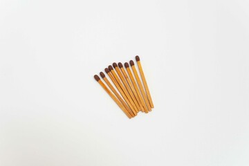 Row of red match sticks isolated on white background. Burnt matches and whole matches on white background.