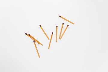 Row of red match sticks isolated on white background. Burnt matches and whole matches on white...