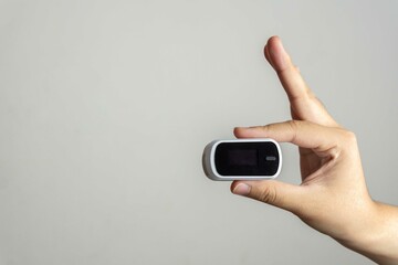 Close up of human finger while using Pulse Oximetry isolated on white background.