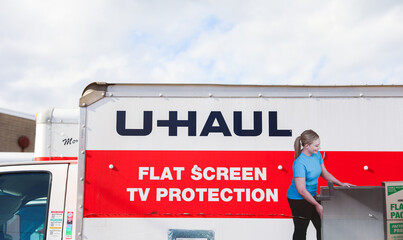 Chicago, IL, USA, November 1, 2023, U-Haul truck parked against a blue sky, symbolizing convenience...