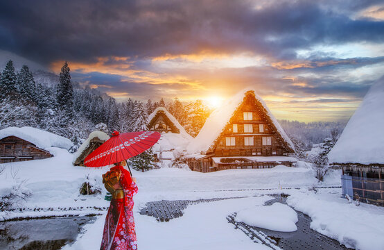 Japanese woman wearing a traditional Japanese kimono at the Shirakawa-go. UNESCO heritage village in the snow in winter at Shirakawa-go, Japan