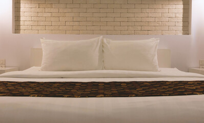 white pillows on white bed in hotel room at night