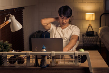 asian man experiencing office syndrome, working overtime during a night shift, freelance work...