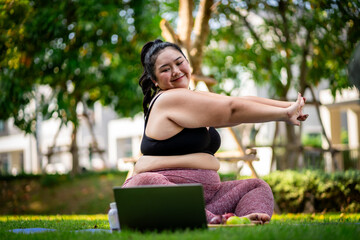 An obese woman who turns to exercise to take care of her health and lose weight on lawn in a fun way