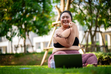 An obese woman who turns to exercise to take care of her health and lose weight on lawn in a fun way