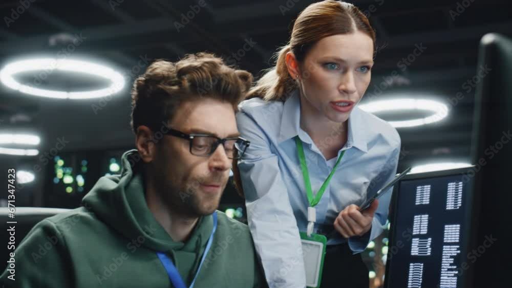 Poster two specialists working datacenter discussing work issues together close up.