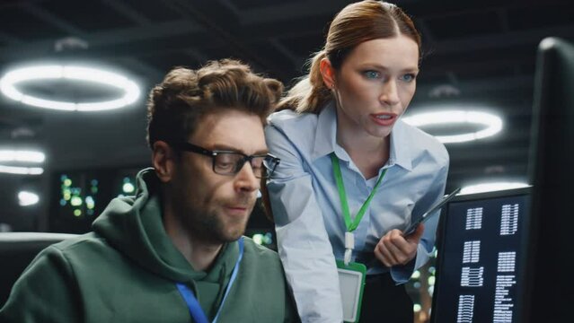 Two specialists working datacenter discussing work issues together close up.  - Powered by Adobe