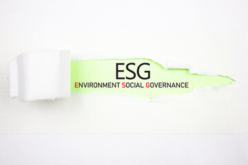 ESG Environmental Social Governance text, abbreviation on a green background of torn paper. ESG...